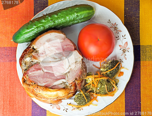 Image of Smoked pork and vegetables on a white plate