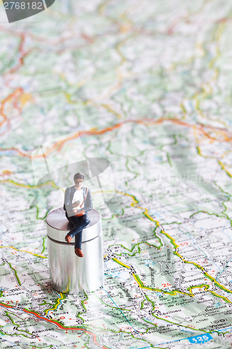 Image of Miniature people in action on a roadmap