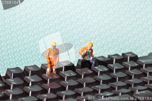 Image of Miniature people in action on a computer keyboard