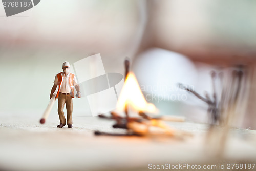 Image of Miniature people in action with matchsticks