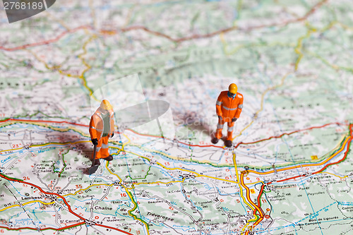 Image of Miniature people in action on a roadmap