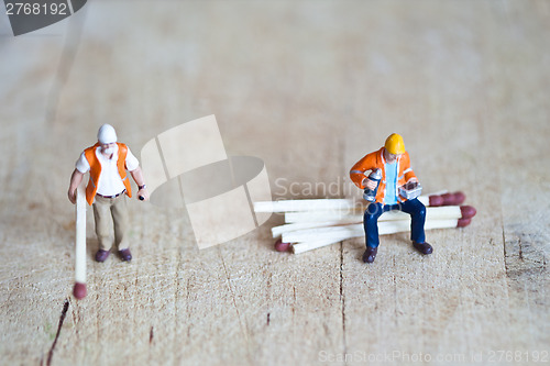 Image of Miniature people in action with matchsticks