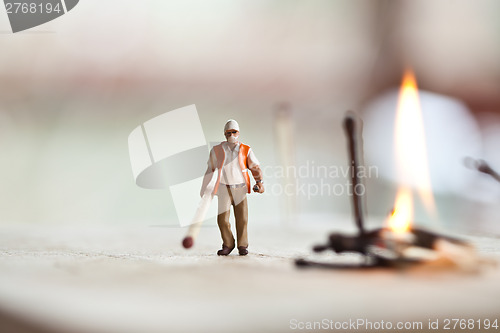 Image of Miniature people in action with matchsticks