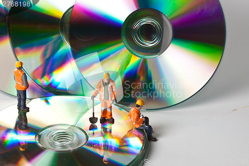 Image of Miniature people in action with CDs