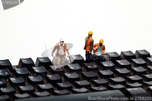 Image of Miniature people in action on a computer keyboard