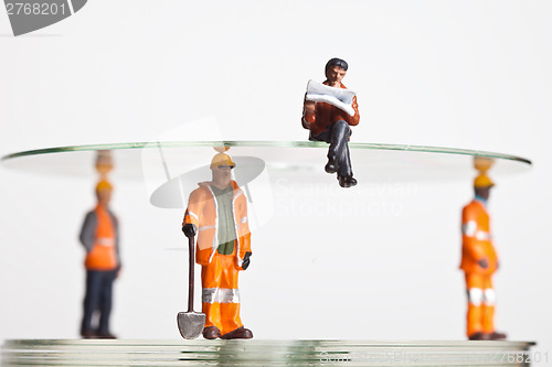 Image of Miniature people in action with CDs