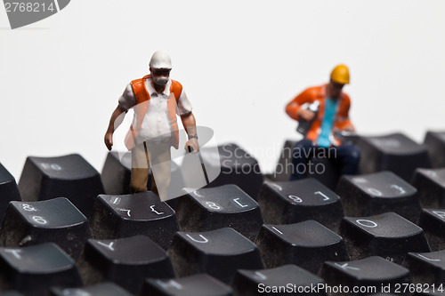 Image of Miniature people in action on a computer keyboard
