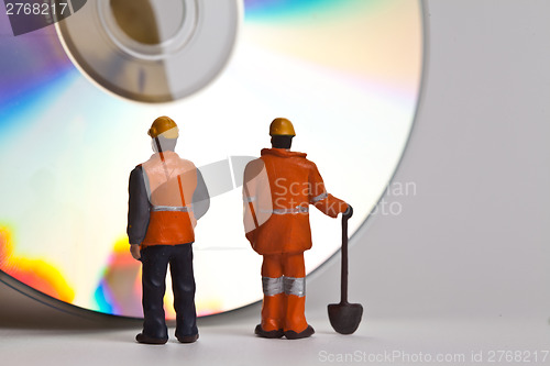 Image of Miniature people in action with CDs
