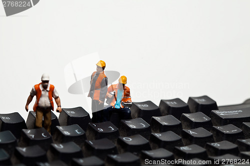 Image of Miniature people in action on a computer keyboard