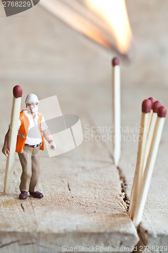 Image of Miniature people in action with matchsticks