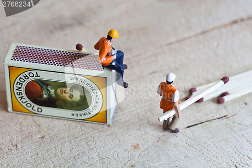 Image of Miniature people in action with matchsticks