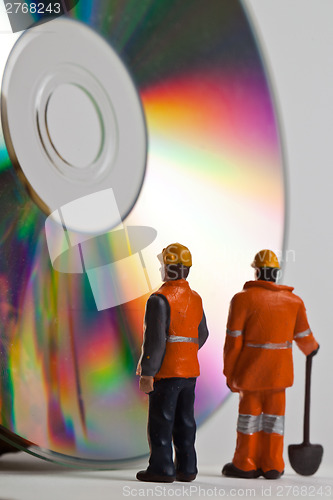 Image of Miniature people in action with CDs