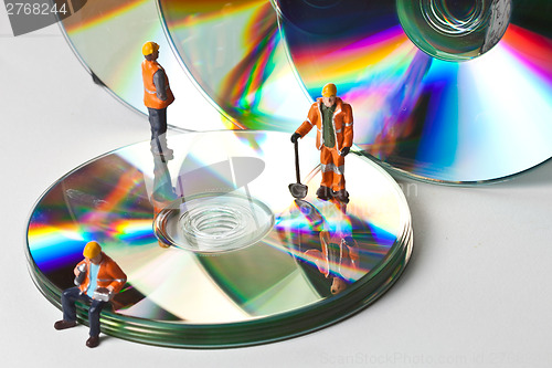 Image of Miniature people in action with CDs