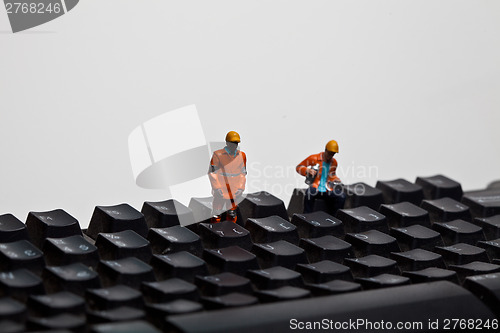 Image of Miniature people in action on a computer keyboard