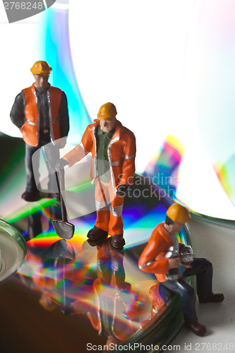 Image of Miniature people in action with CDs