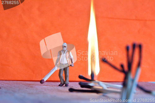 Image of Miniature people in action with matchsticks