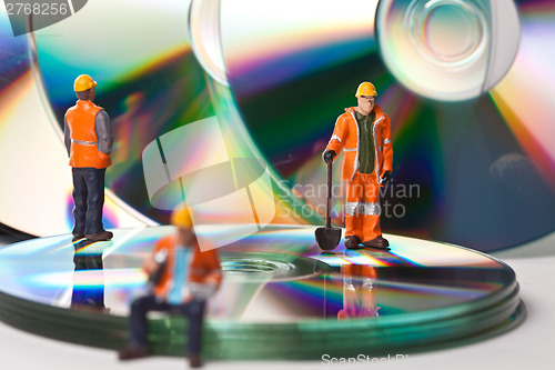 Image of Miniature people in action with CDs