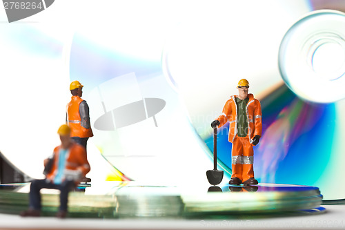 Image of Miniature people in action with CDs