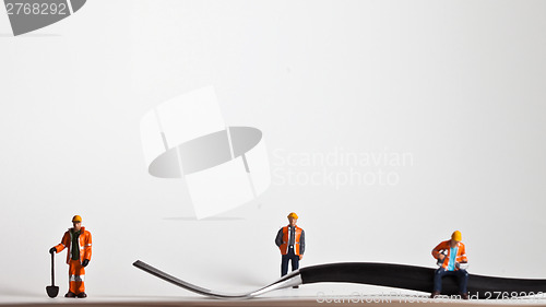Image of Miniature people in action worker on a fork