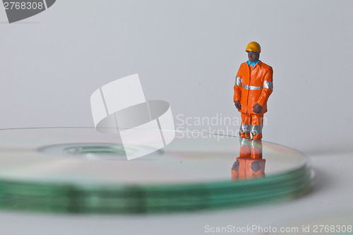 Image of Miniature people in action with CDs