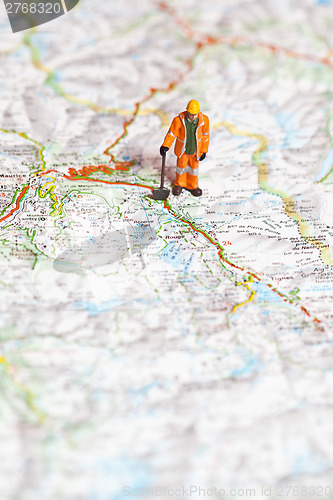 Image of Miniature people in action on a roadmap