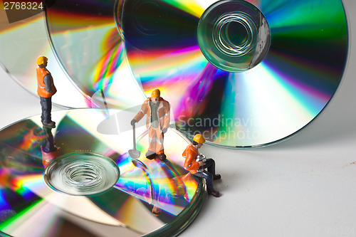 Image of Miniature people in action with CDs