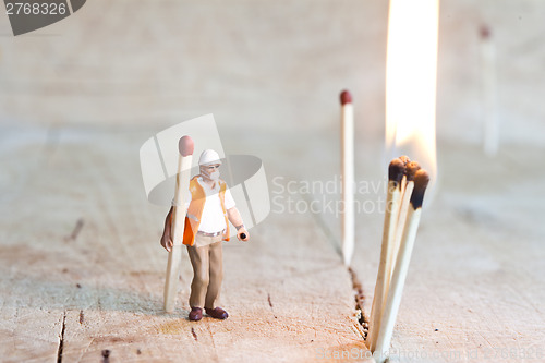 Image of Miniature people in action with matchsticks