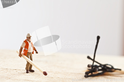 Image of Miniature people in action with matchsticks