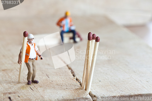 Image of Miniature people in action with matchsticks