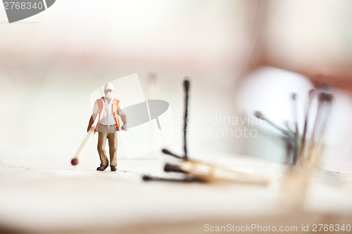 Image of Miniature people in action with matchsticks