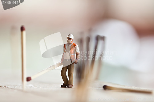 Image of Miniature people in action with matchsticks