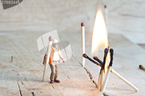 Image of Miniature people in action with matchsticks