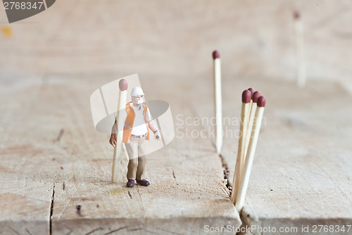 Image of Miniature people in action with matchsticks