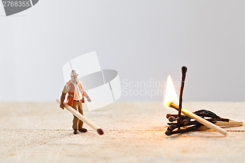 Image of Miniature people in action with matchsticks