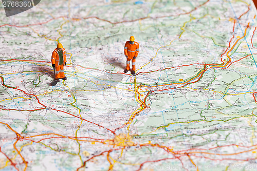 Image of Miniature people in action on a roadmap