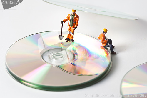 Image of Miniature people in action with CDs