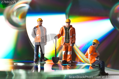 Image of Miniature people in action with CDs