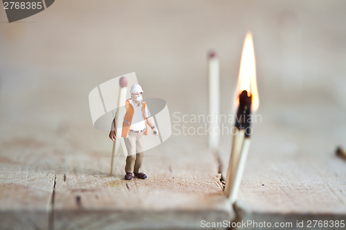 Image of Miniature people in action with matchsticks