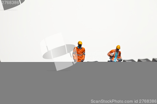 Image of Miniature people in action on a computer keyboard