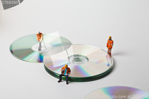 Image of Miniature people in action with CDs
