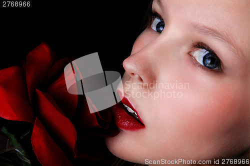Image of Closeup face with rose.