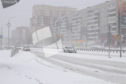 Image of The cars brought by snow, stand on a road roadside.