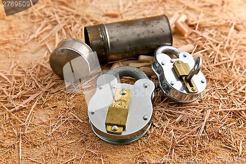 Image of Two Metal Locks on top of Wooden Shavings