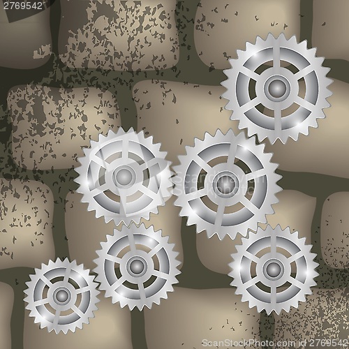 Image of gears on a brick background