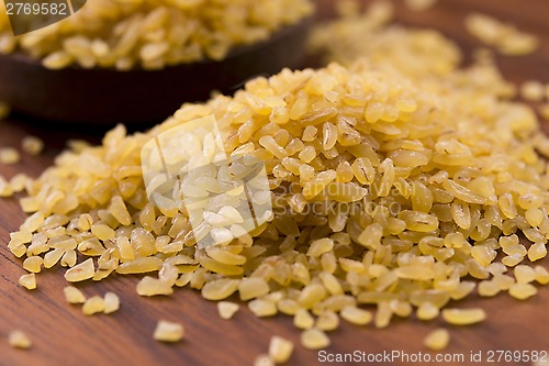 Image of bulgur wheat in wooden spoon