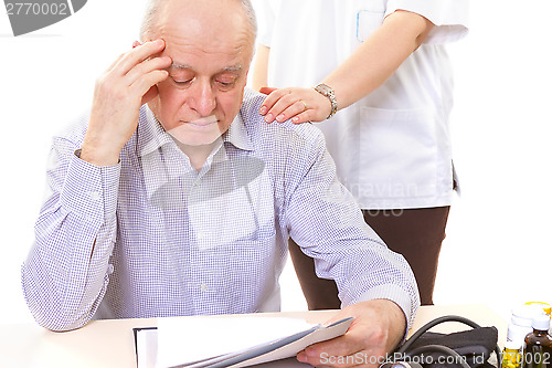 Image of doctor comforting mature stressed patient with headache