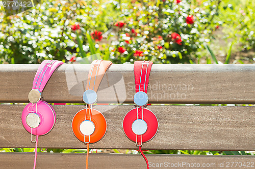 Image of Three varicolored headphones of different colors