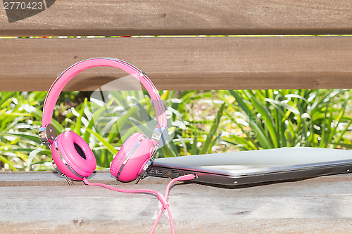 Image of Vividl pink headphones and laptop