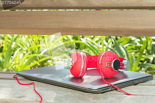 Image of Colorful red headphones and notebook