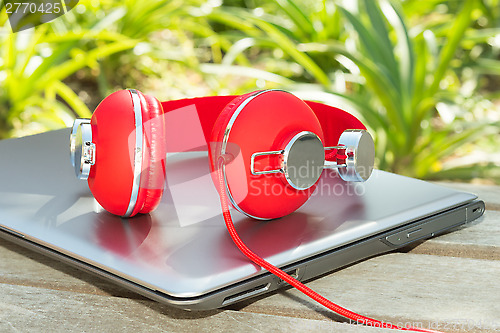 Image of Vivid red headphones and laptop